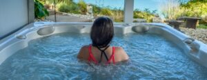 How can a daily hot tub soak help improve physical wellness?