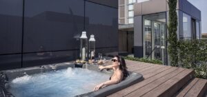 How can daily hot tub use improve physical wellness?